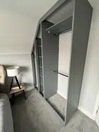 Dust grey hinged wardrobe interior built to fit the shape of the room, fitted in Eaglescliffe